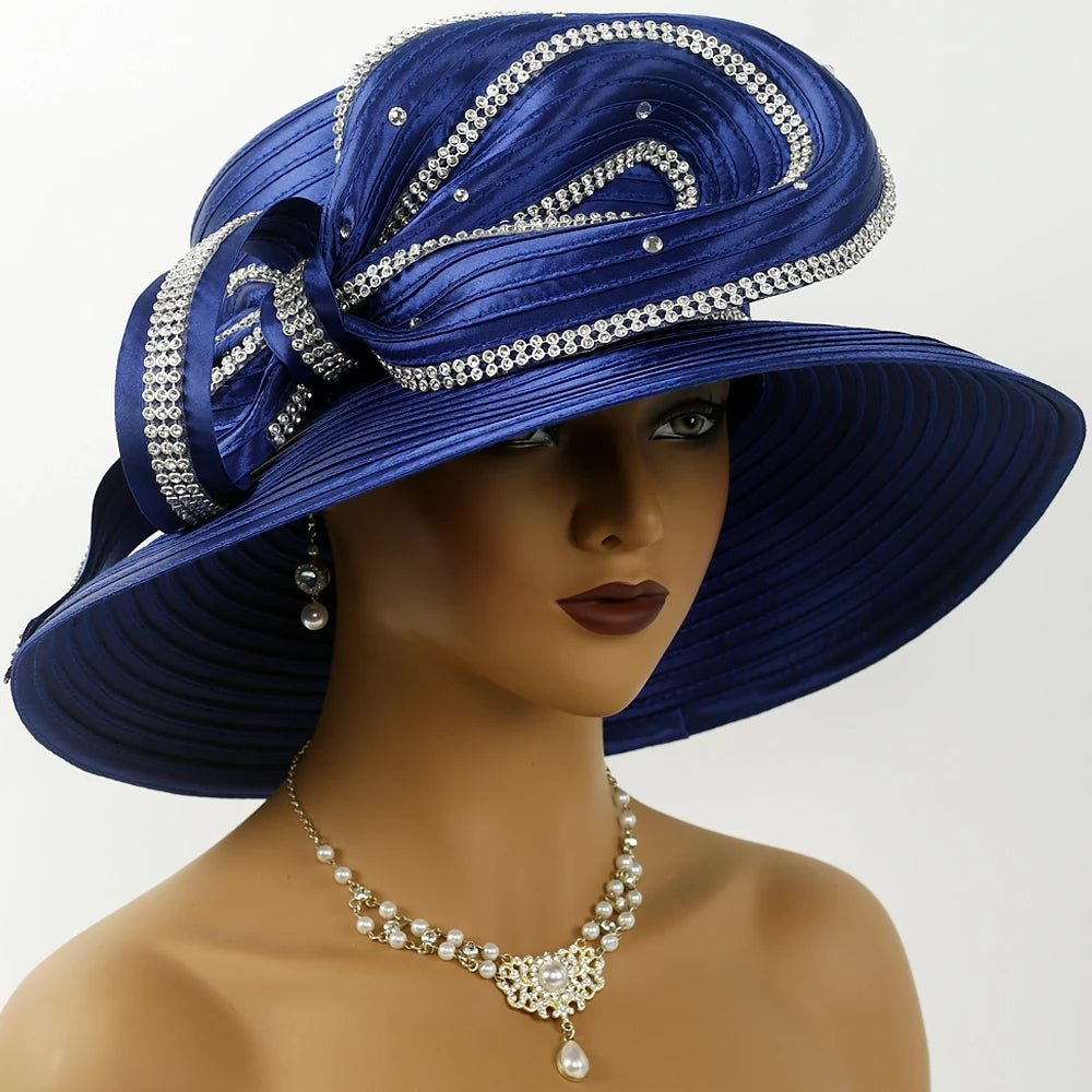 Front view of a poised African-American woman wearing a royal blue church hat with rhinestone embellishments, pearl earrings, and necklace, ideal for Sunday services.
