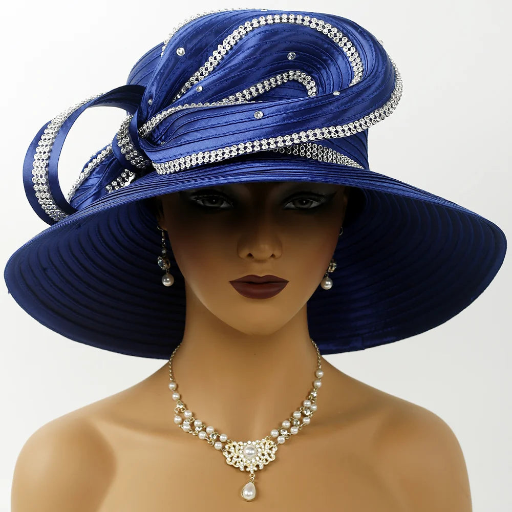 Side profile of an elegant African-American woman wearing a royal blue wide brim church hat with rhinestone bow detail, pearl earrings, and matching necklace.