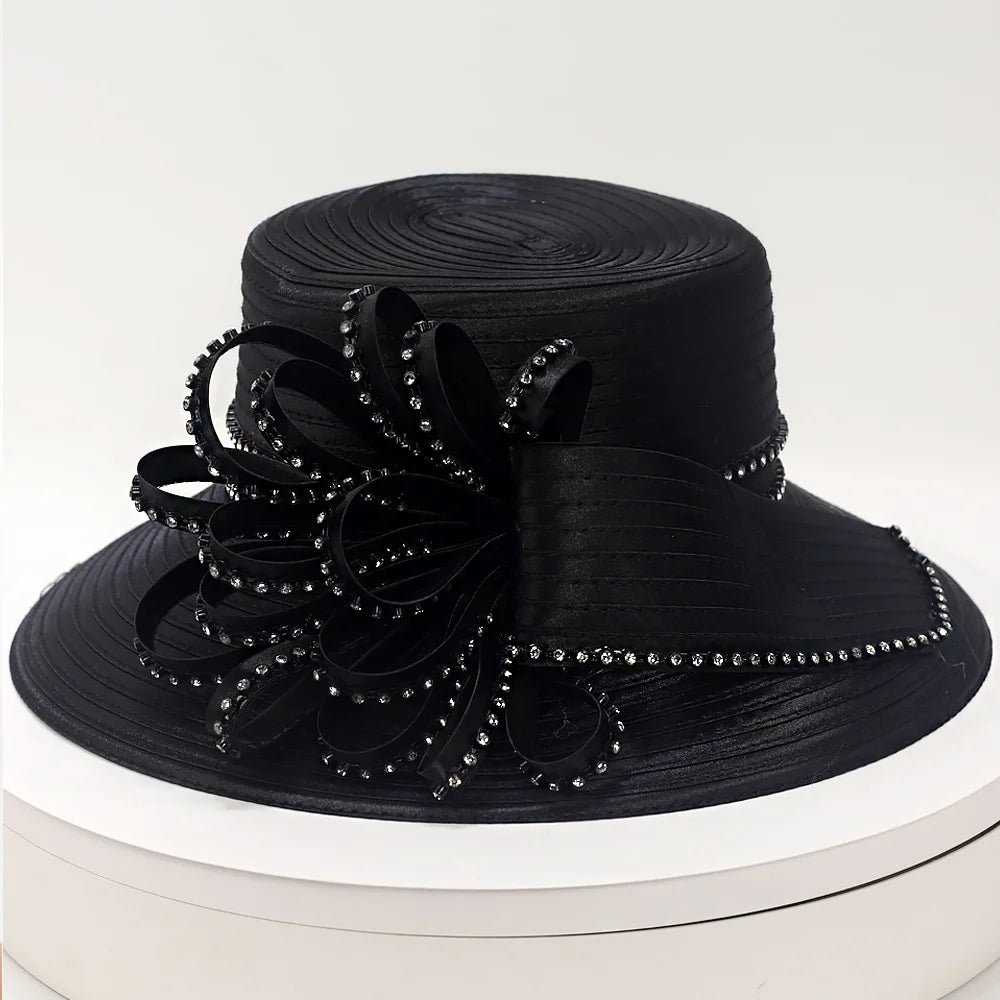 Stylish black church hat with intricate crystal detailing, featuring a decorative ribbon design, ideal for weddings and special occasions.