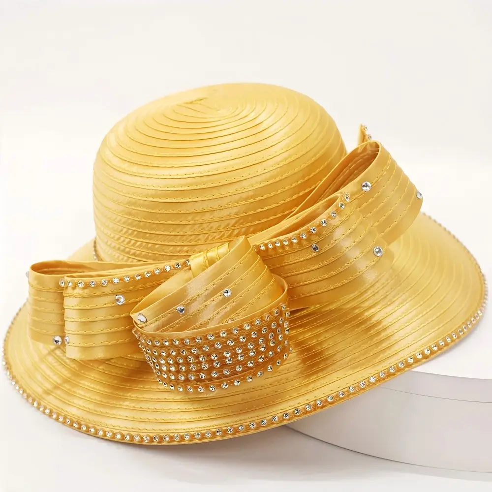 Side angle of a gold church hat with crystal bow design, perfect for events