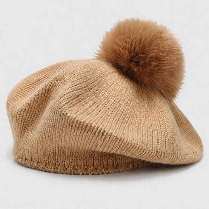 Khaki beret with pom-pom, perfect for a stylish and cozy winter outfit. Knitted design for comfort.