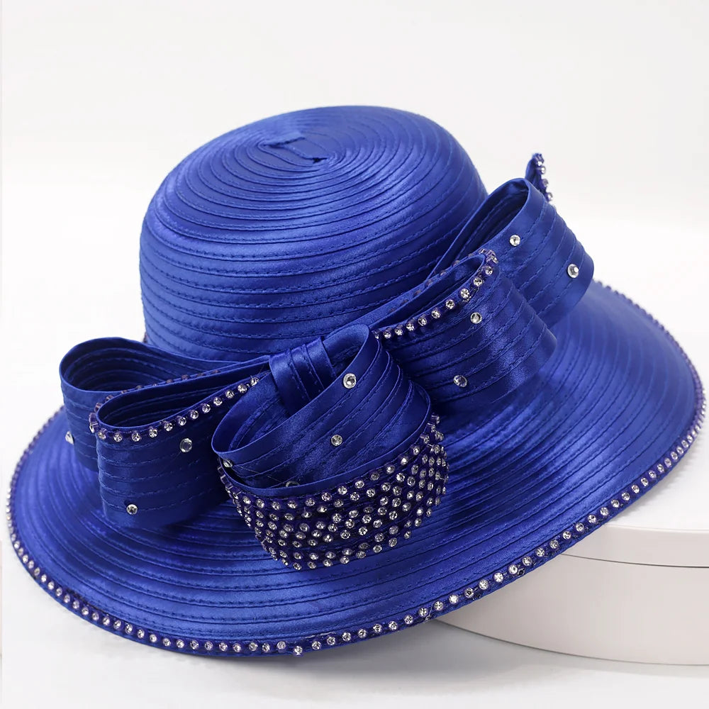 Side profile of royal blue wide-brim hat with rhinestone accents.