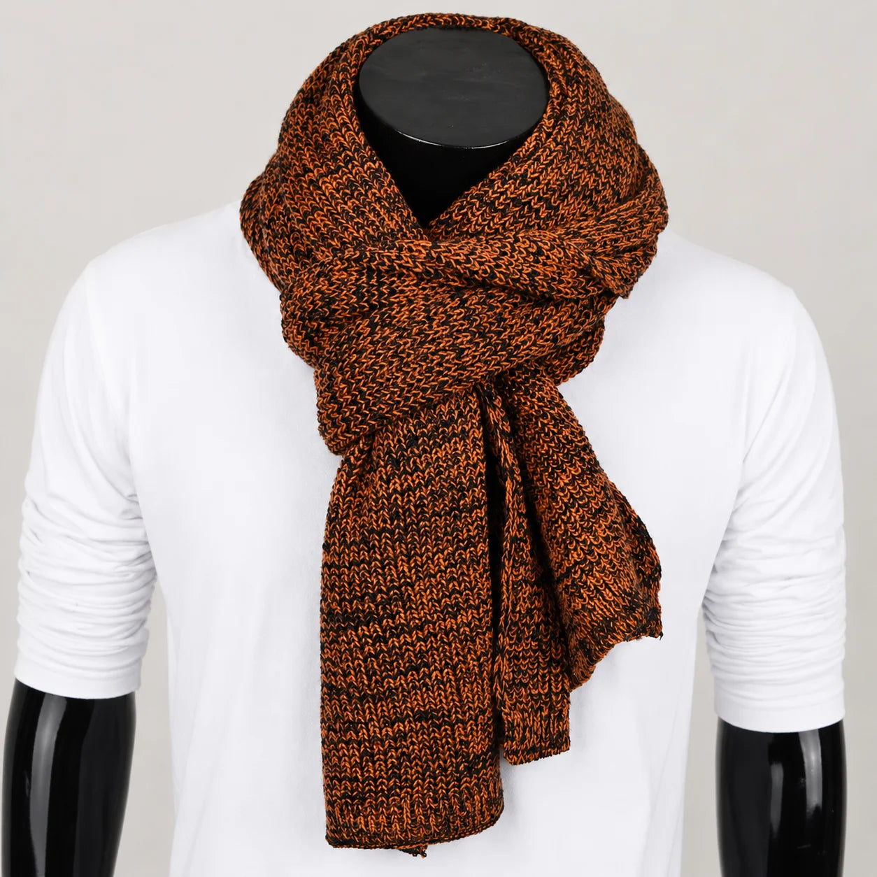 Rust orange melange knit scarf on mannequin, warm textured winter accessory for urban style