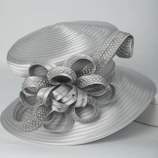 Side view of silver satin church hat with sparkling rhinestone flower detail, ideal for formal church events.