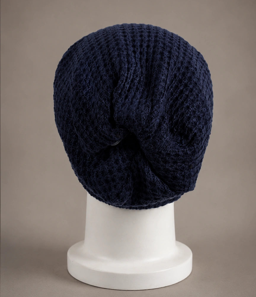 Navy blue slouch beanie back view showing relaxed long drape and soft gathered knit structure