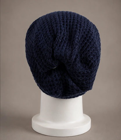 Navy blue slouch beanie back view showing relaxed long drape and soft gathered knit structure