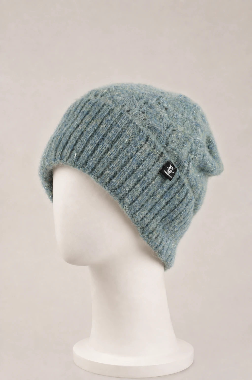 fuzzy sequin cuffed beanie displayed on a matte white mannequin.
