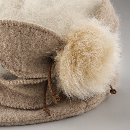 Close-up of fixed wool petals and genuine rabbit-fur pom on an Angora cloche hat