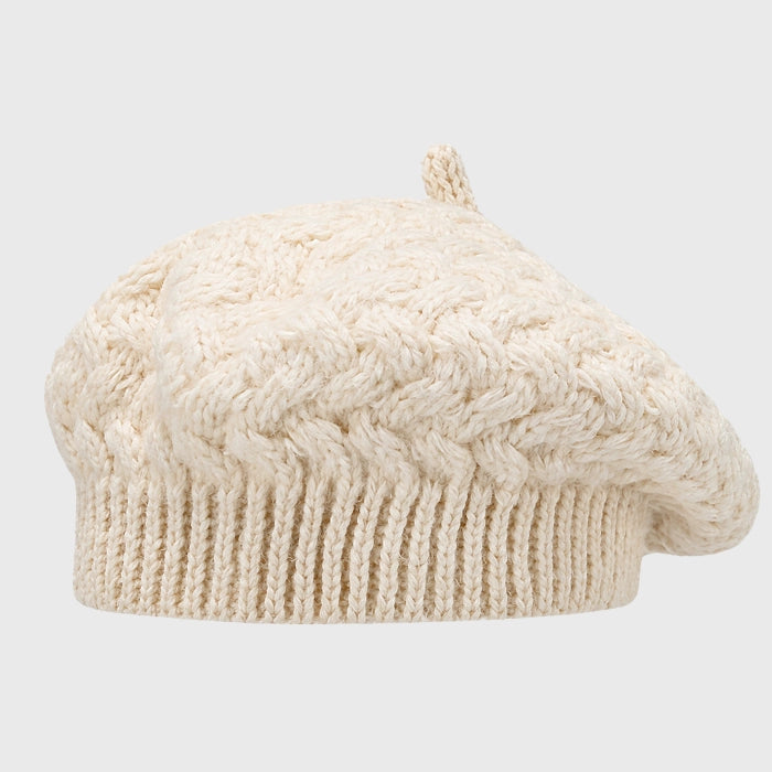 Elegant beige cable knit beret, offering both style and warmth. Adjustable fit and cozy crochet design for winter fashion.
