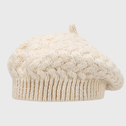 Elegant beige cable knit beret, offering both style and warmth. Adjustable fit and cozy crochet design for winter fashion.