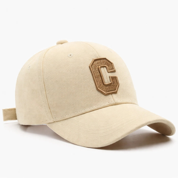 Chic beige cotton baseball cap featuring an embroidered 'C' logo, ideal for a relaxed and fashionable look.