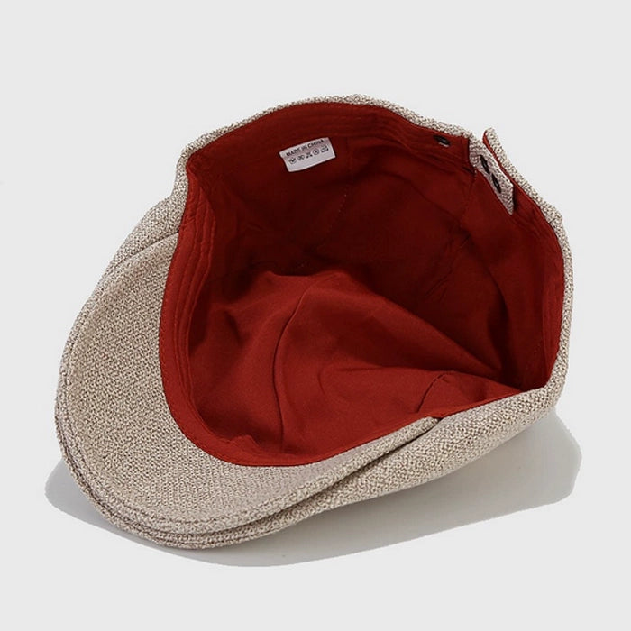 Interior view of beige flat cap showing soft lining and red fabric. This stylish Ivy cap is made of high-quality cotton, offering comfort and durability.