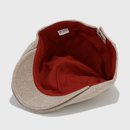Interior view of beige flat cap showing soft lining and red fabric. This stylish Ivy cap is made of high-quality cotton, offering comfort and durability.