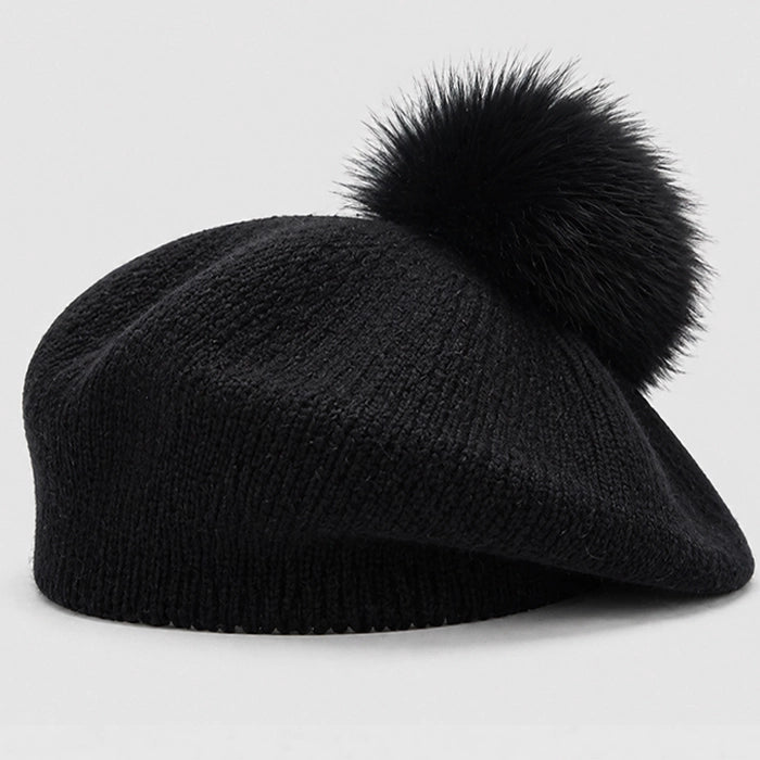 Black beret with a pom-pom, perfect for a chic and cozy winter look. Knitted fabric for warmth
