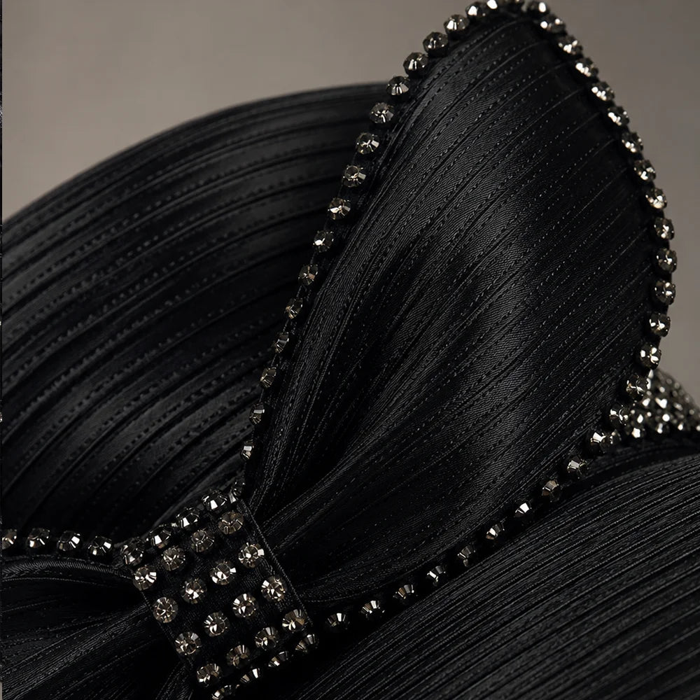 Close-up detail of black church hat with rhinestone bow trim, luxury satin formal hat for women’s church fashion and special occasions