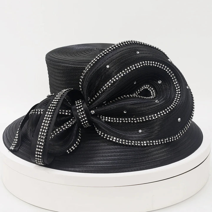 Front view of a black wide brim church hat for women with rhinestone trim and satin bow.