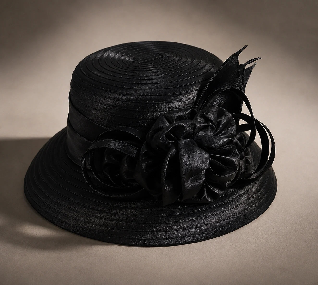 Flat lay of black cloche short brim church hat with ribbon flower, elegant and premium FORBUSITE hat