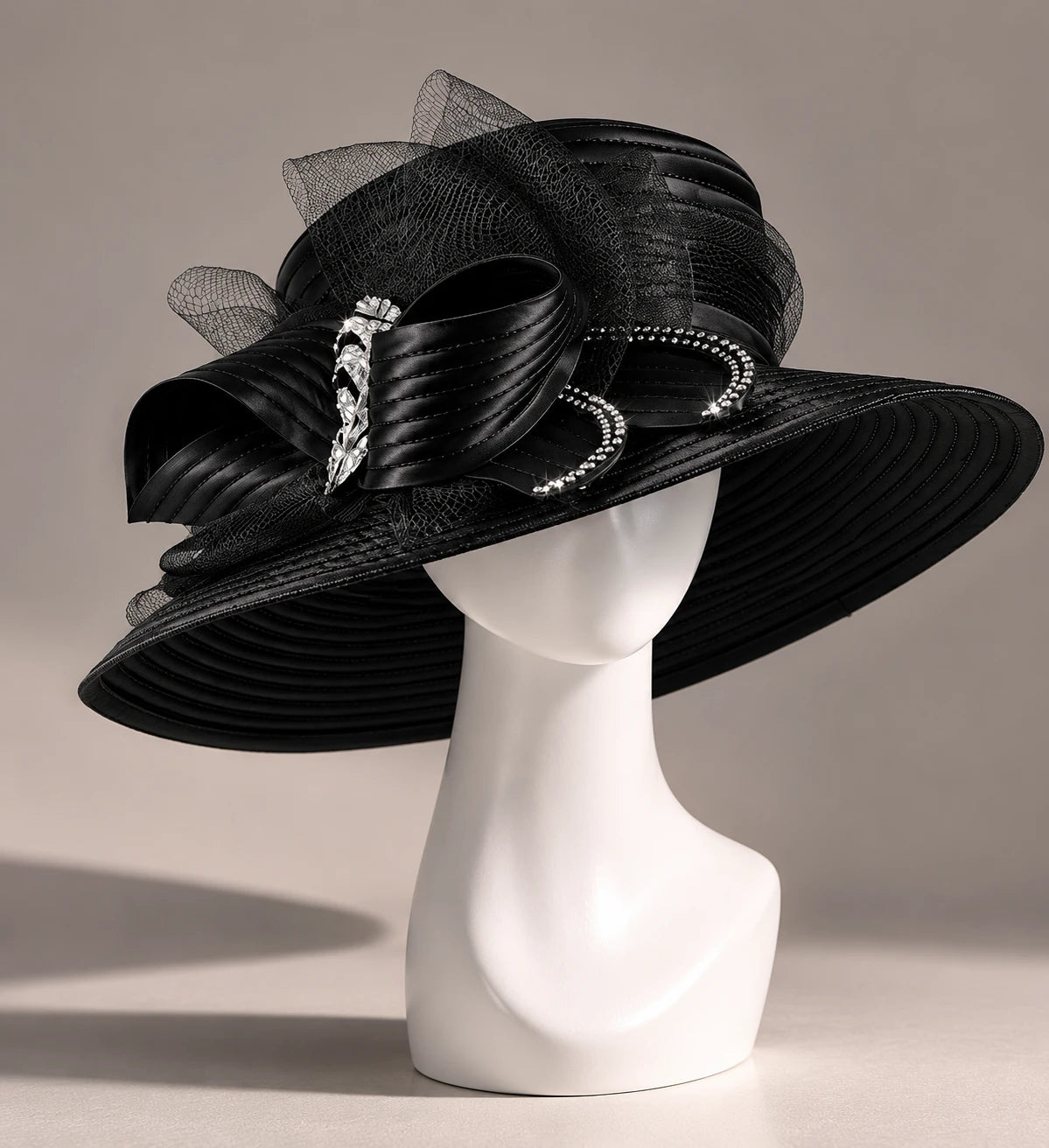 Side view of black formal church hat on mannequin featuring decorative ribbon loops, rhinestone accents and elegant wide brim design