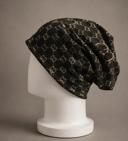 Black jacquard slouchy beanie hat with double C print, oversized baggy fit, lightweight knit beanie for men and women, side view on mannequin.