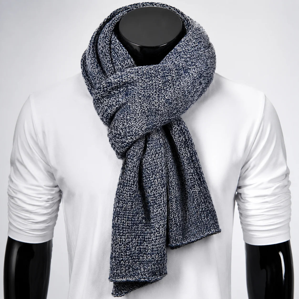 Black melange knit scarf on mannequin, soft ribbed texture for urban winter layering