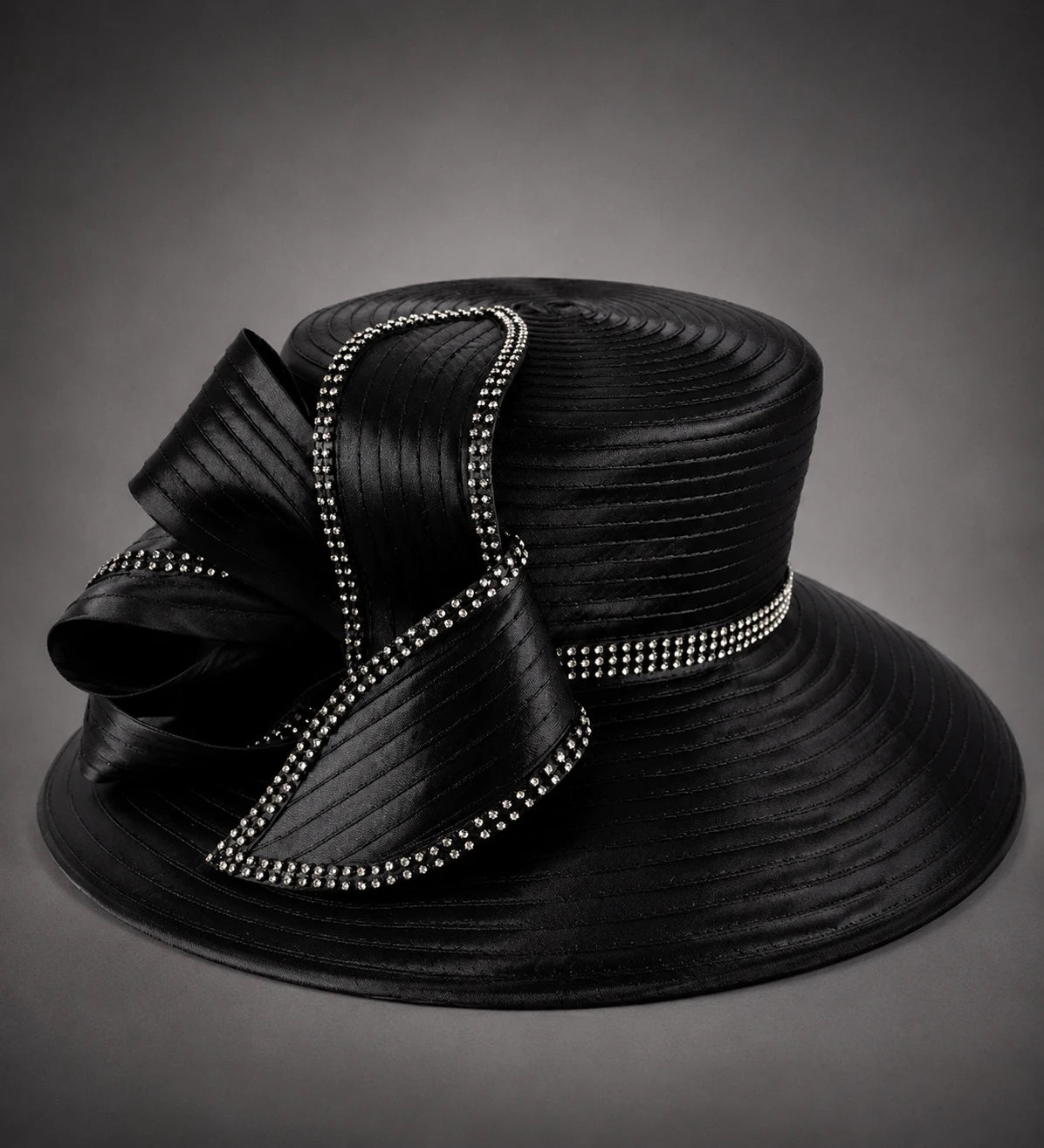 Black rhinestone church hat with pleated ribbon bow and wide brim close up