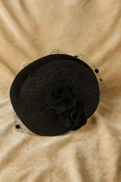 Black fascinator hat with roses and birdcage veil for funeral or church