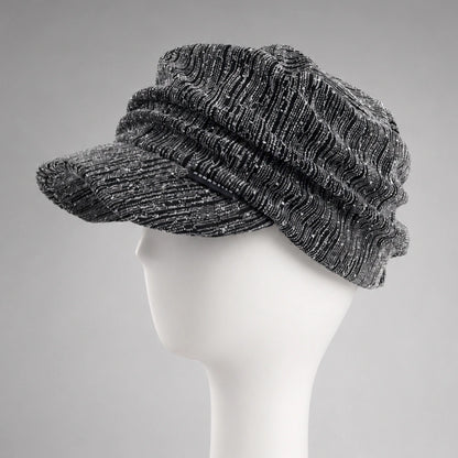 Black and silver women’s ruched visor cap showing textured fabric and soft crown drape