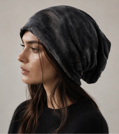 Black slouchy beanie on female model, side profile showing long relaxed fit, distressed texture and modern everyday style