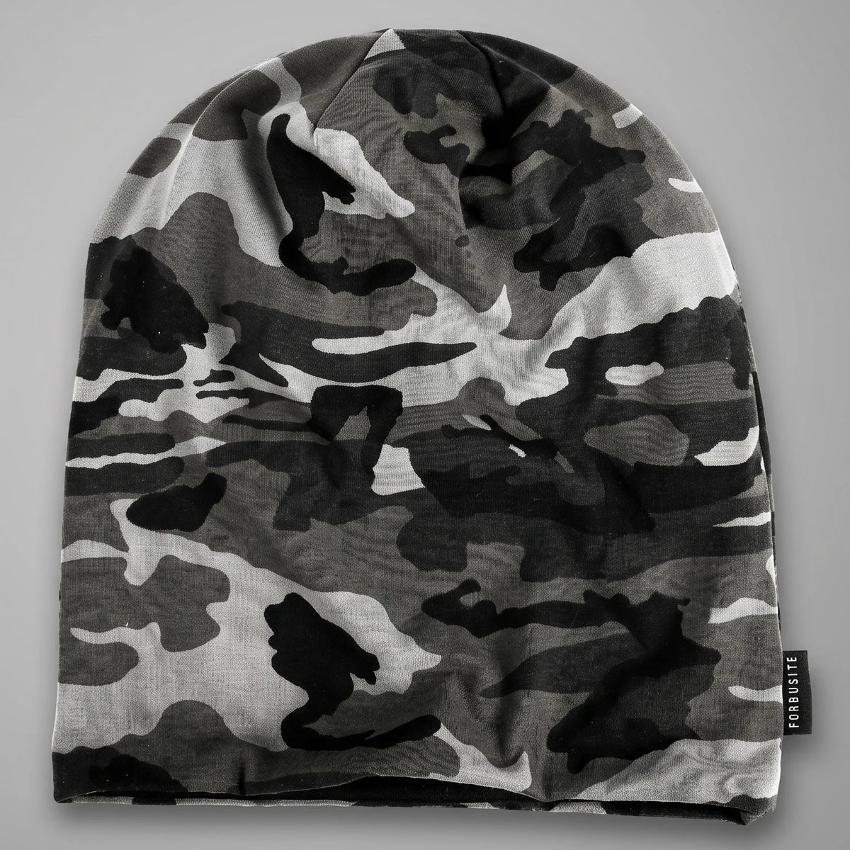 Black and white camo slouchy beanie laid flat, showing its uncuffed shape