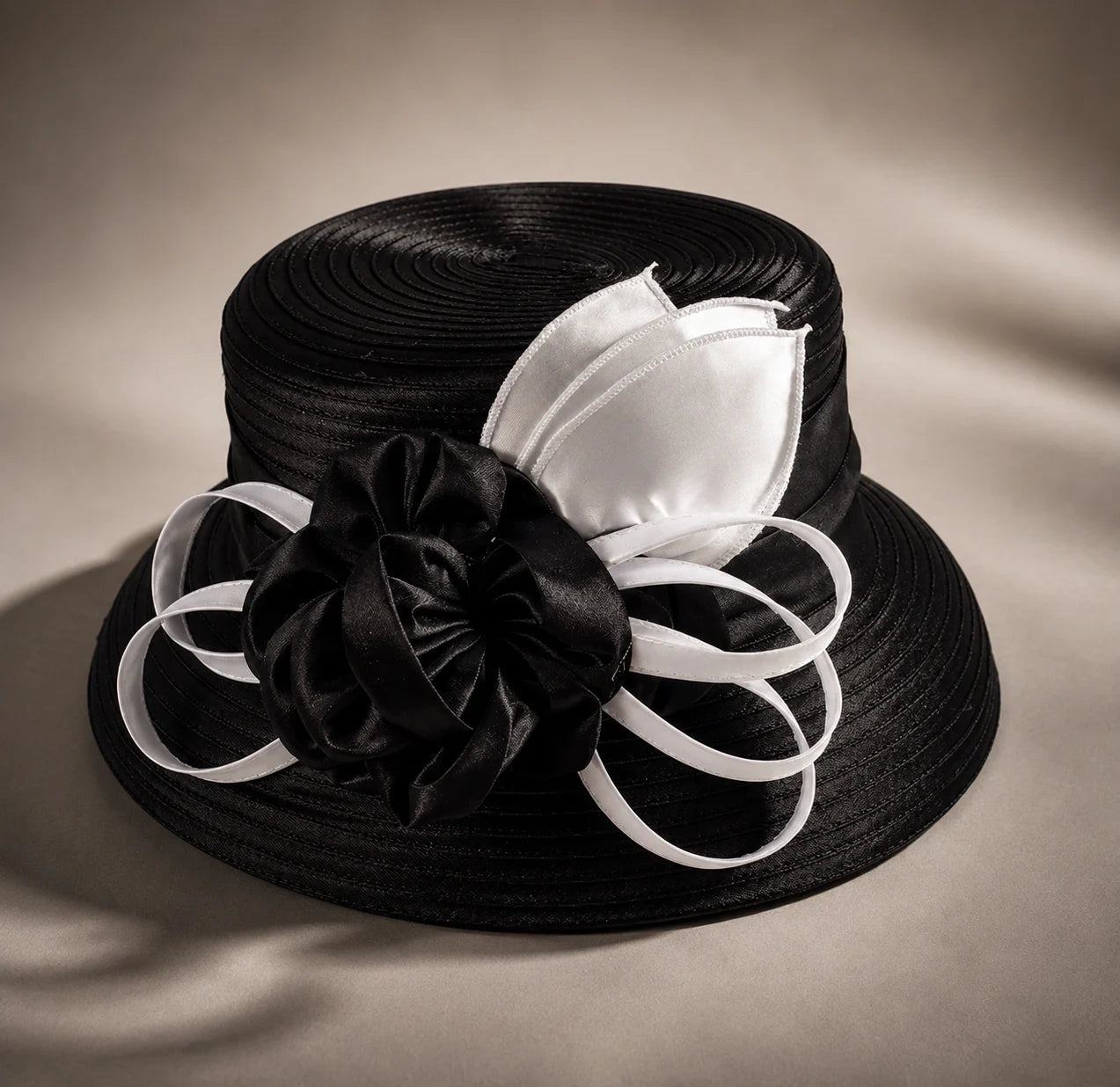 Flat lay of black and white cloche short brim church hat with ribbon flower detail, elegant formal hat for women, FORBUSITE premium hat