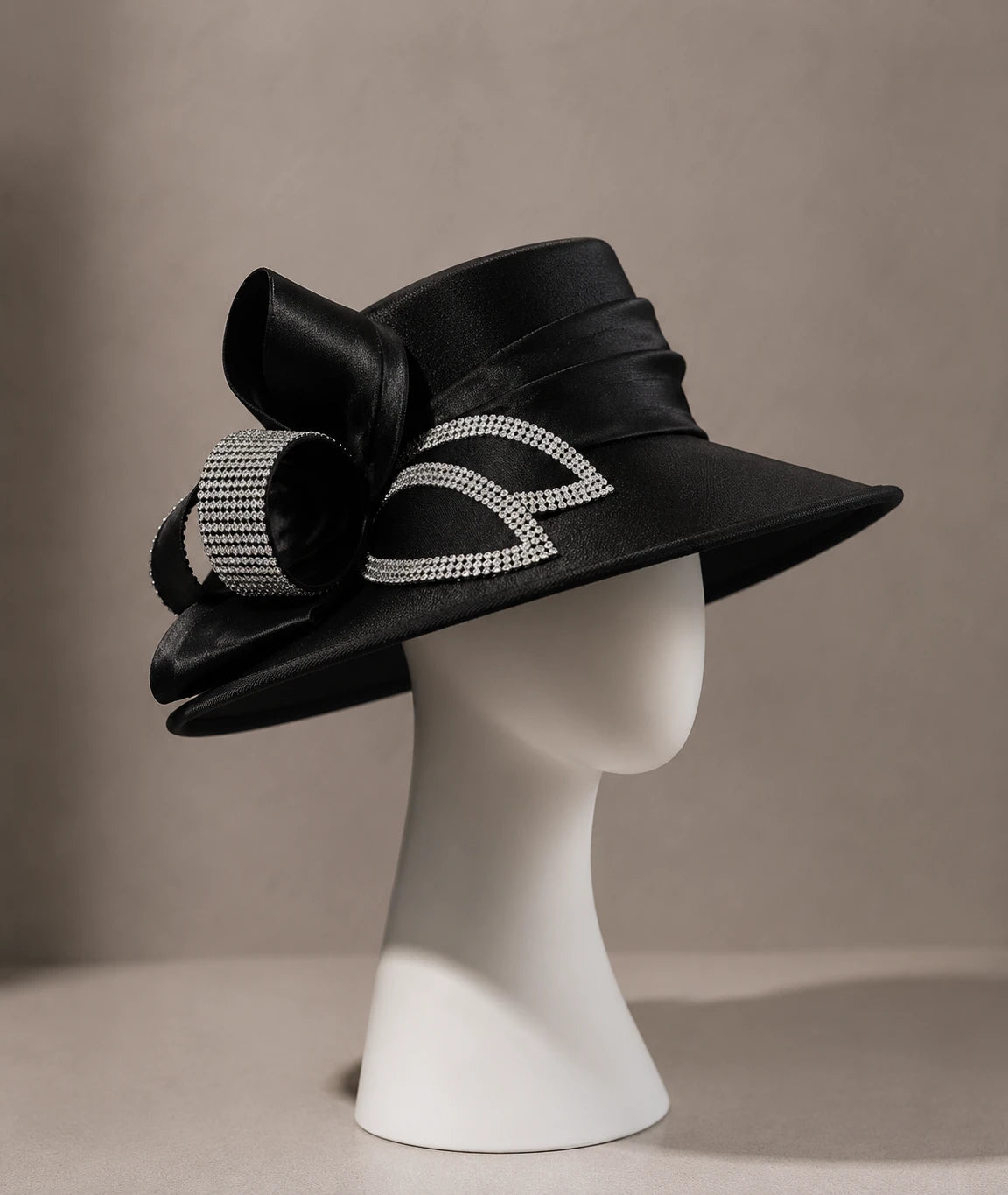 Black wide brim church hat with rhinestone ribbon displayed on minimalist mannequin