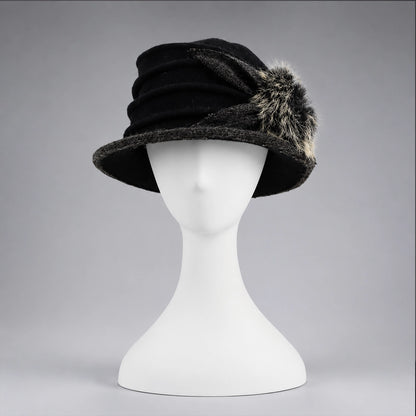 Black women’s boiled wool cloche hat with layered ruching and fixed fuzzy pom