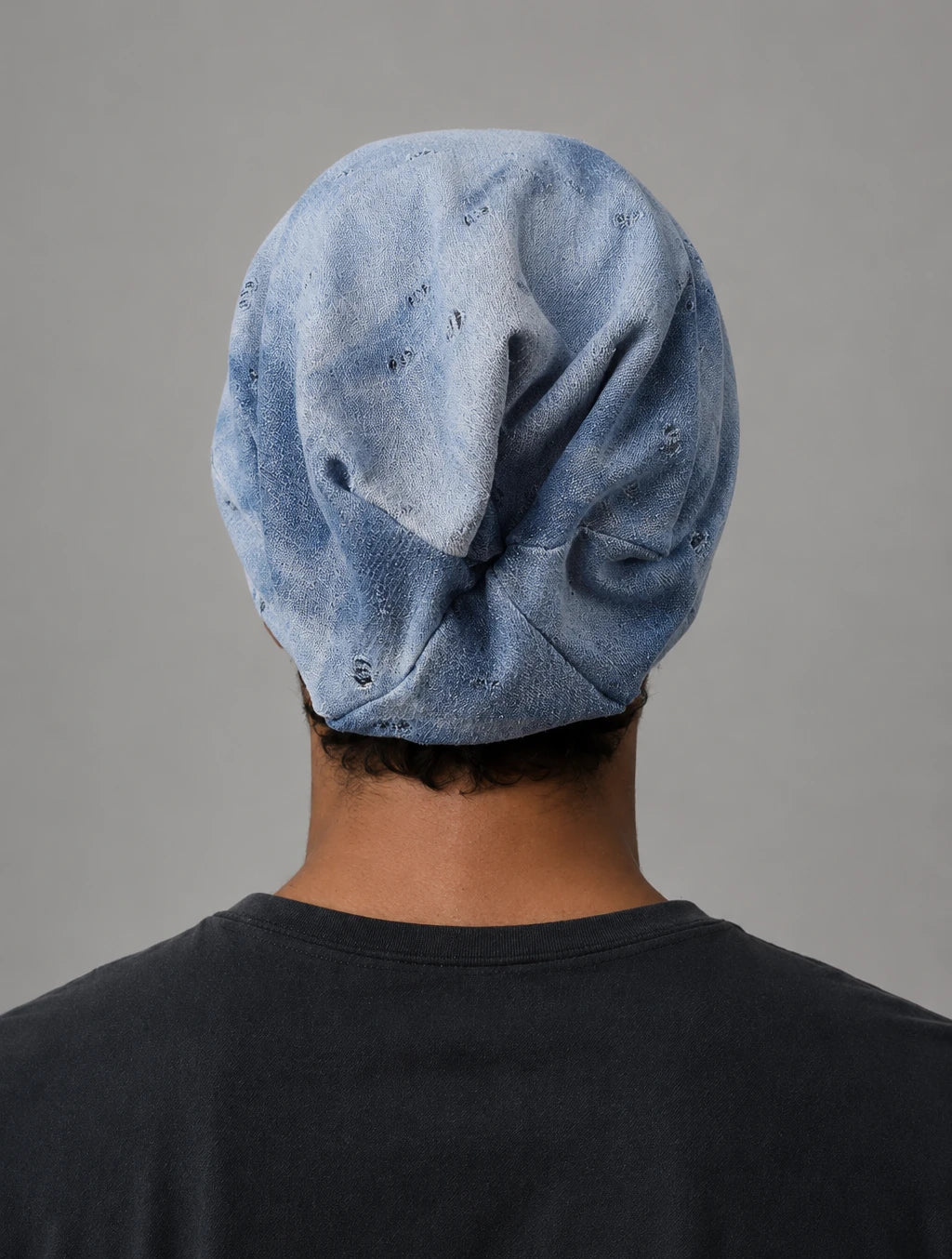 Back view of blue grey slouch beanie showing natural oversized drape, soft folds and relaxed long beanie shape