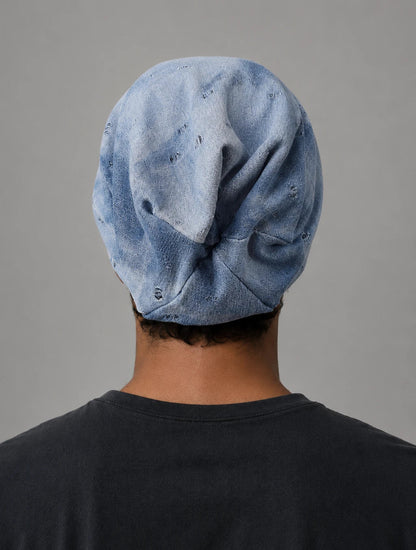 Back view of blue grey slouch beanie showing natural oversized drape, soft folds and relaxed long beanie shape