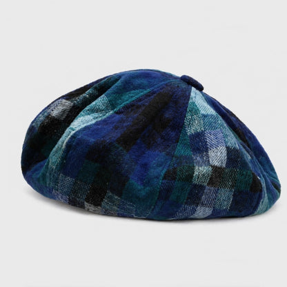 Blue tartan beret cap for women, offering a vintage look with a comfortable adjustable fit for daily wear.