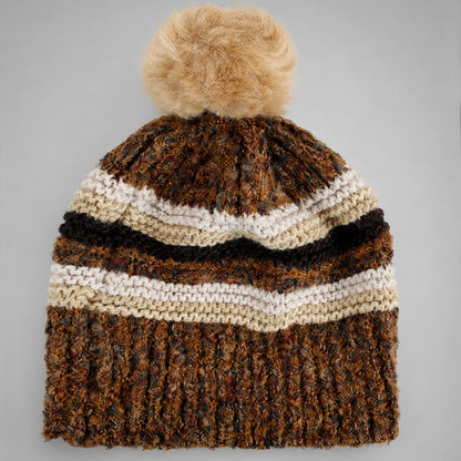 Brown striped pom pom beanie flat lay with ribbed lower section