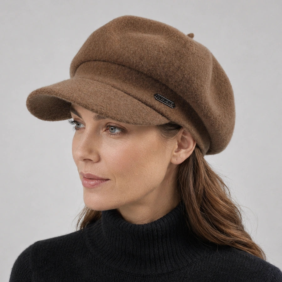 Woman wearing a brown wool newsboy cap with a short visor