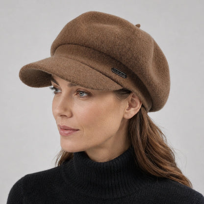 Woman wearing a brown wool newsboy cap with a short visor