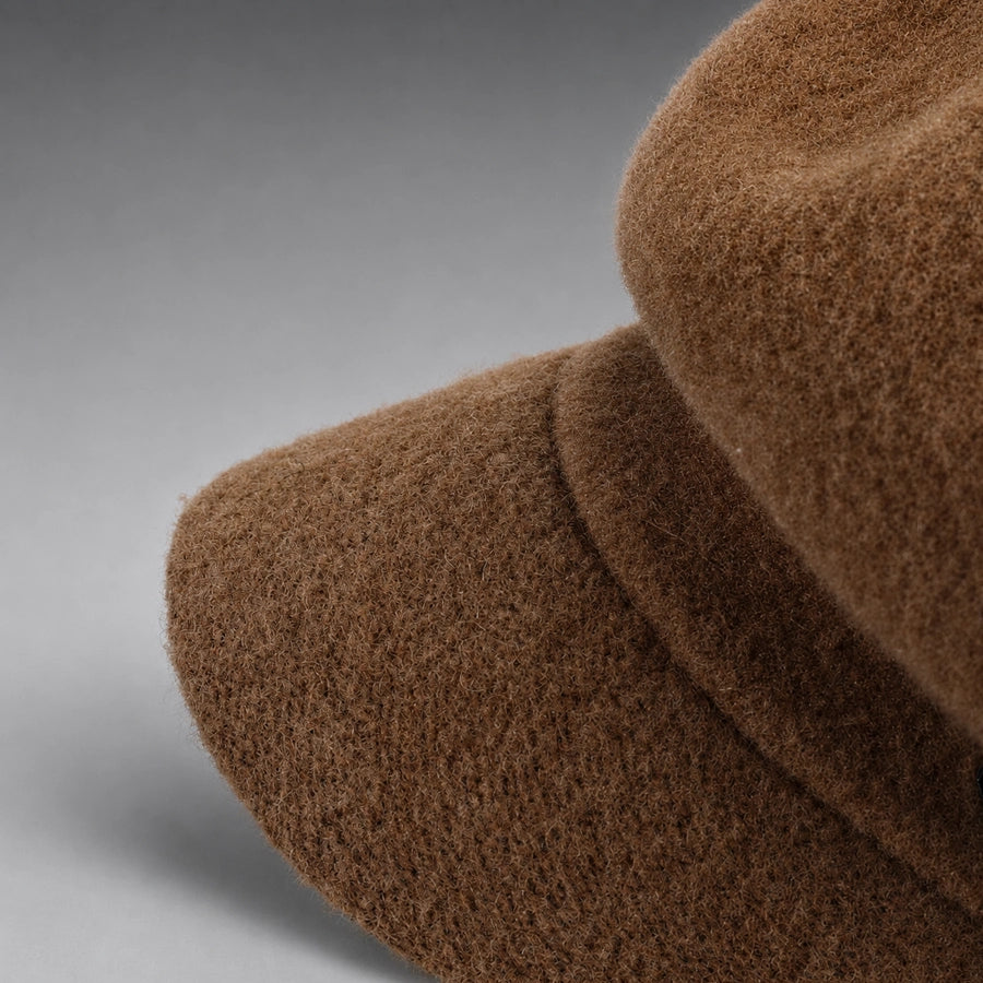 Close-up of brown wool-covered visor and fuzzy surface texture