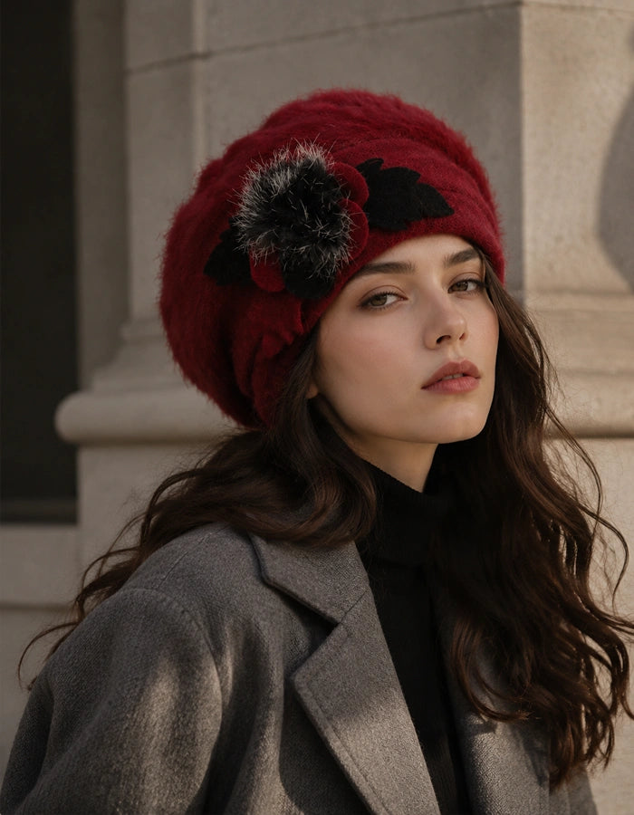 Burgundy angora wool beret with black flower accent styled with grey winter coat
