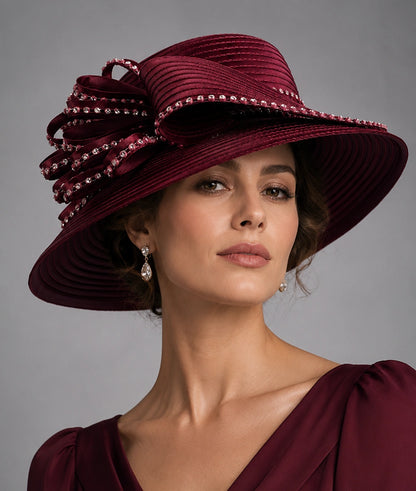 Burgundy church hat with wide brim rhinestone bow worn by woman for Sunday service