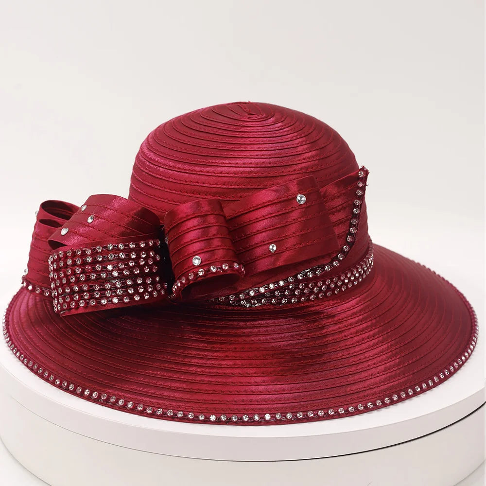 Elegant burgundy church hat with rhinestone bow and wide brim for women.
