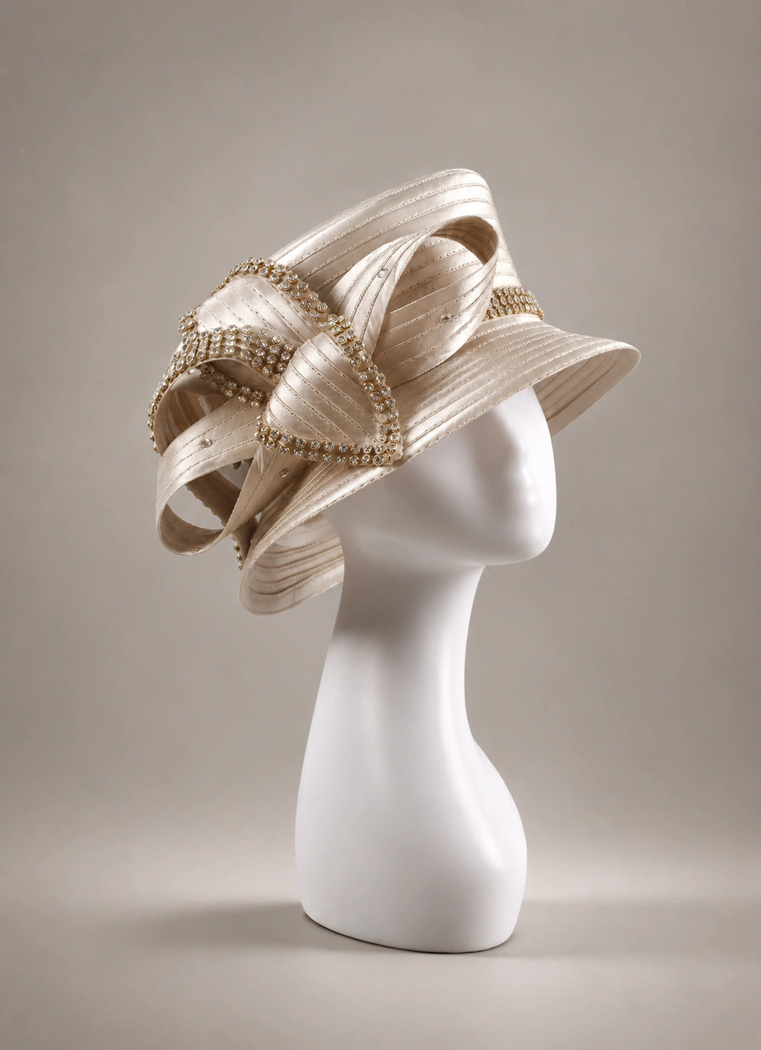 Champagne church hat on mannequin, side angle showing satin ribbon and rhinestone details, ideal for formal occasions and church events