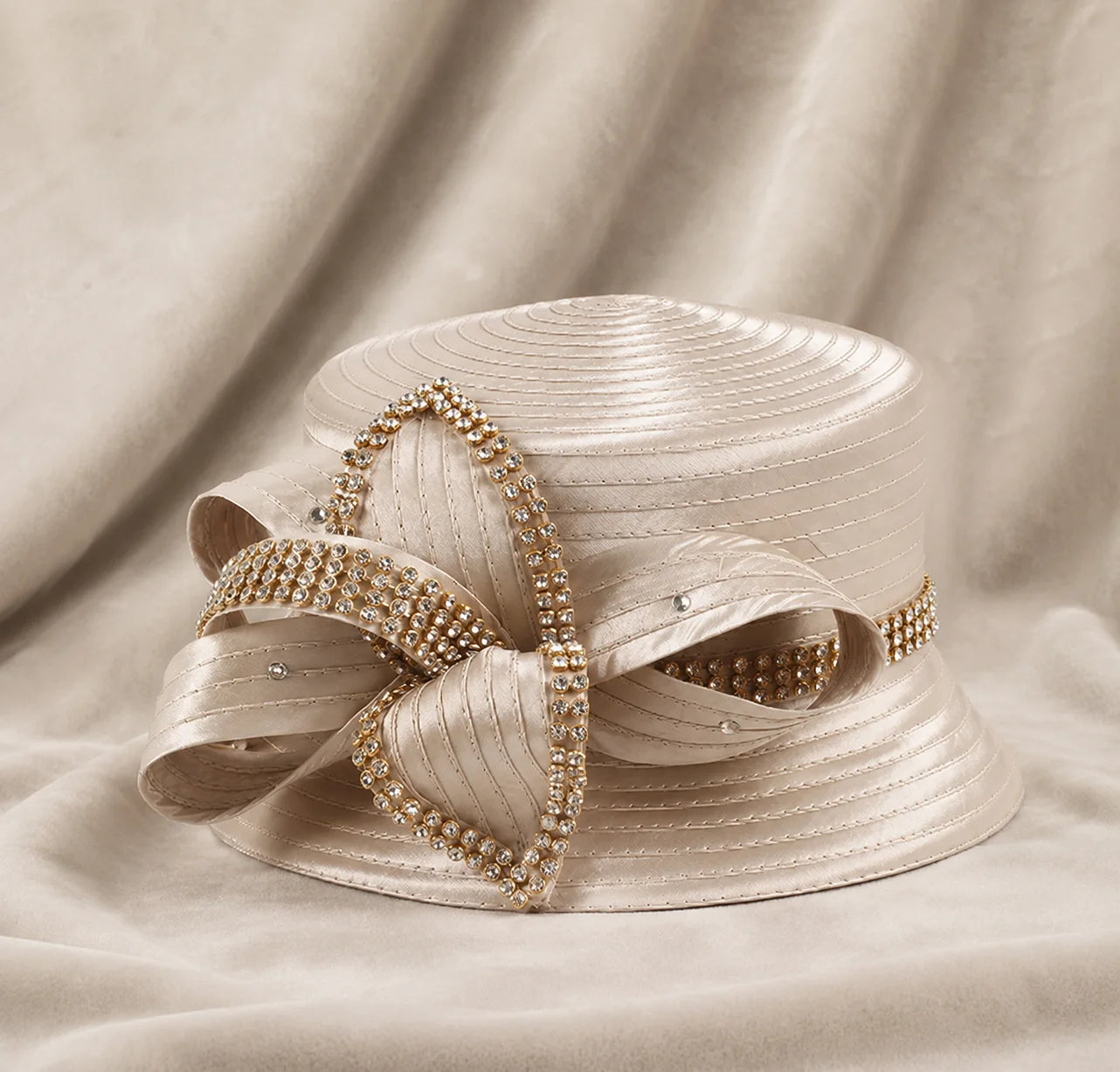 Close-up of champagne satin church hat with rhinestone trim, highlighting high-quality material and luxurious craftsmanship