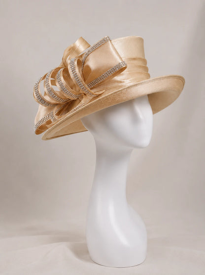 Side view of champagne wide brim church hat on mannequin with rhinestone ribbon bow, elegant women’s formal occasion hat