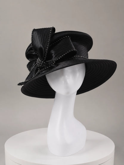 Front view of stylish black church hat worn by model, featuring rhinestone decorations and high-end formal style