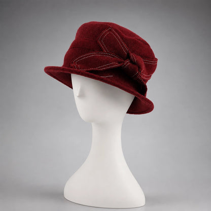 Front view of a claret wool felt cloche hat with short all-around brim