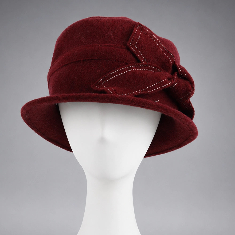 Side view of a claret women’s wool felt cloche hat with fixed bow detail