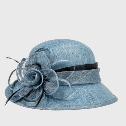 Sophisticated blue cloche sinamay hat with a stylish black ribbon and floral feather detail, perfect for afternoon teas or social functions.