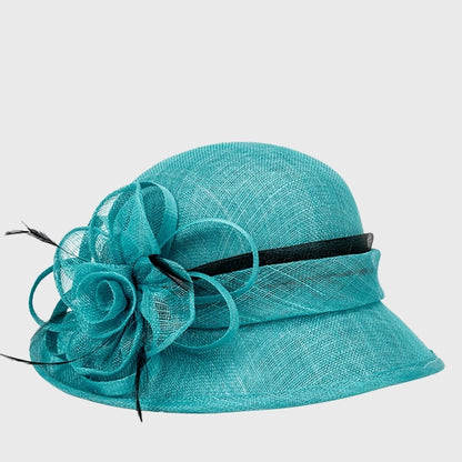 Vibrant teal cloche sinamay hat adorned with a delicate flower and black ribbon, ideal for tea parties and special gatherings.